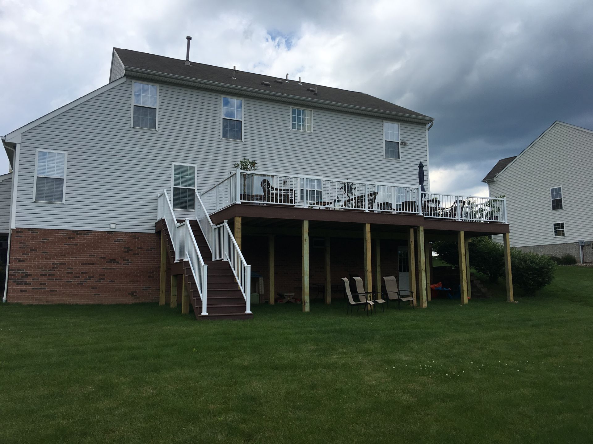 The back of a house with a large deck and stairs