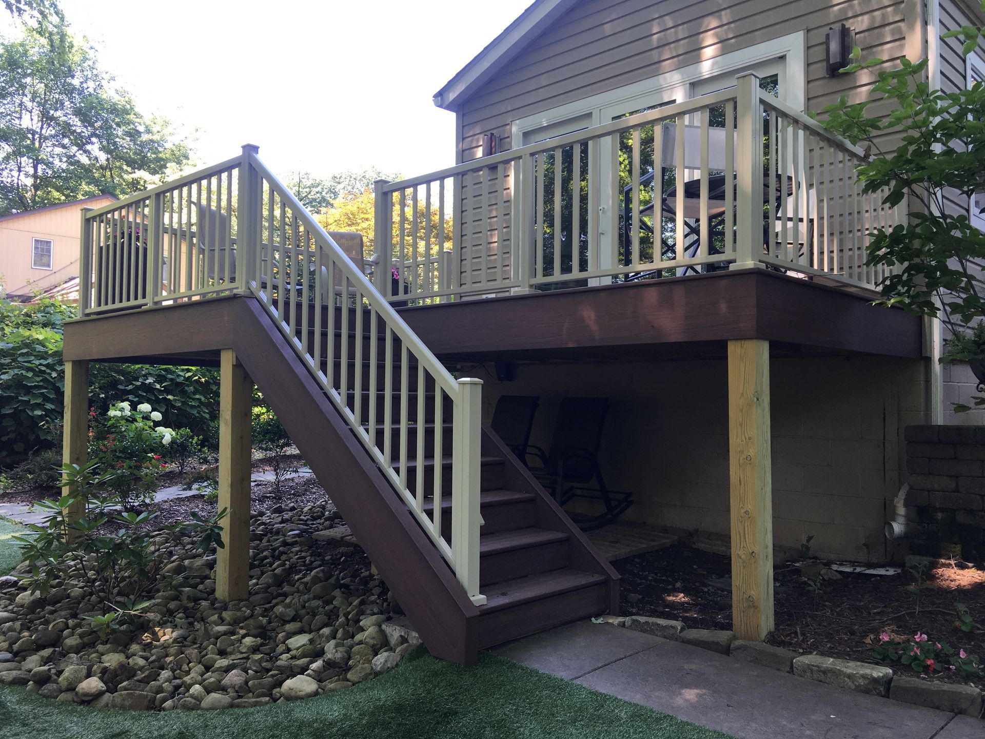 A wooden deck with stairs leading up to it