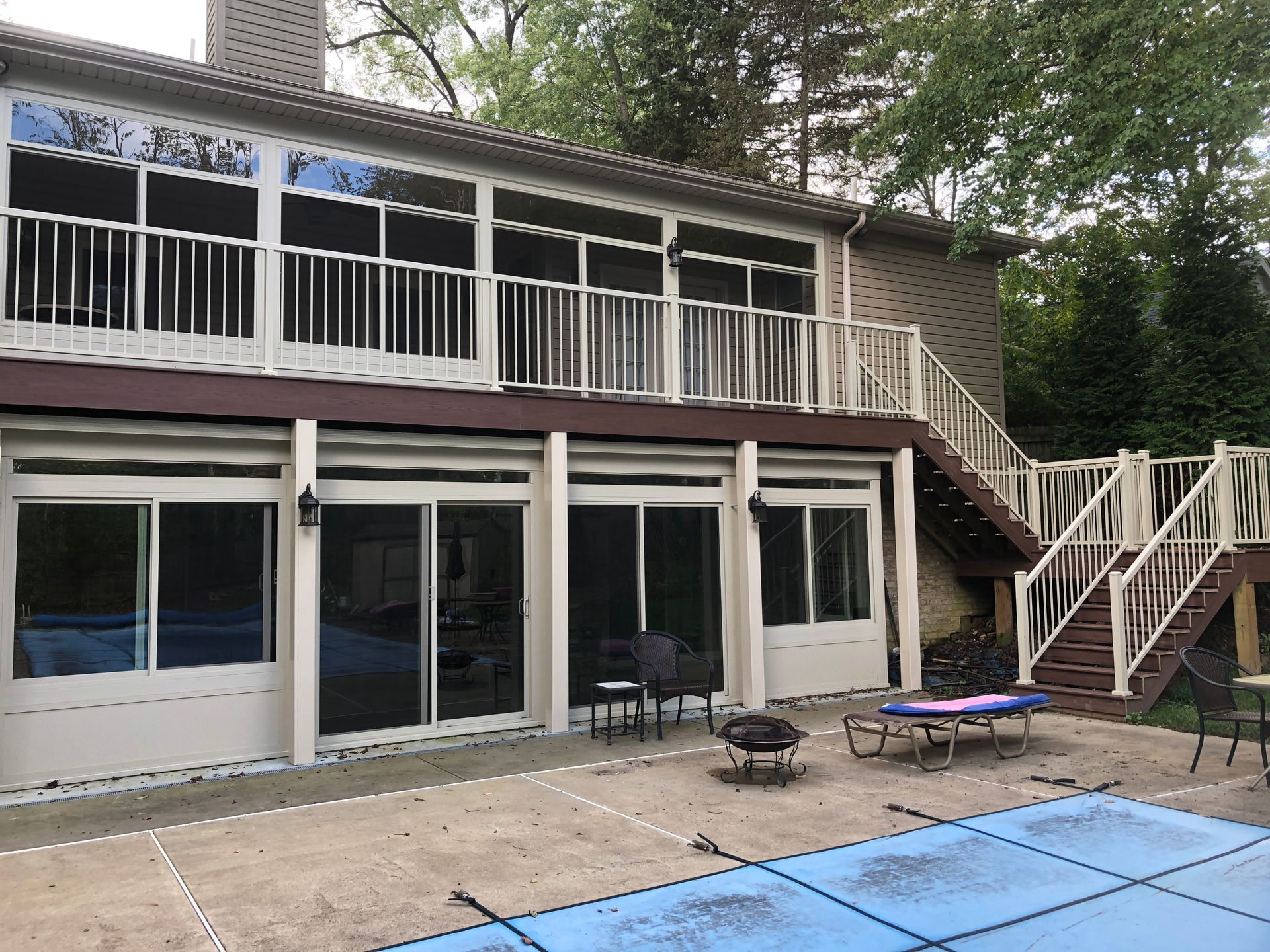 A house with a screened in porch and stairs