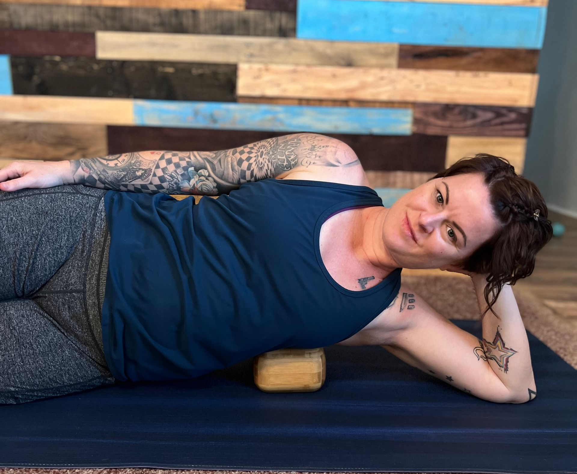 Tyana demonstrating Block Therapy fascia decompression technique using a Block Therapy Block