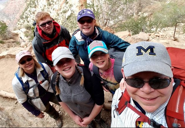 A family selfie with Adam Stewart during a hike