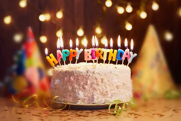 A birthday cake with candles that say