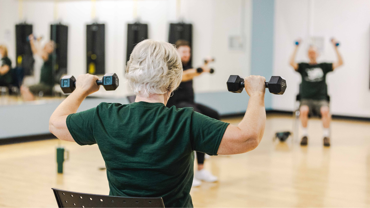 senior woman holding weights 