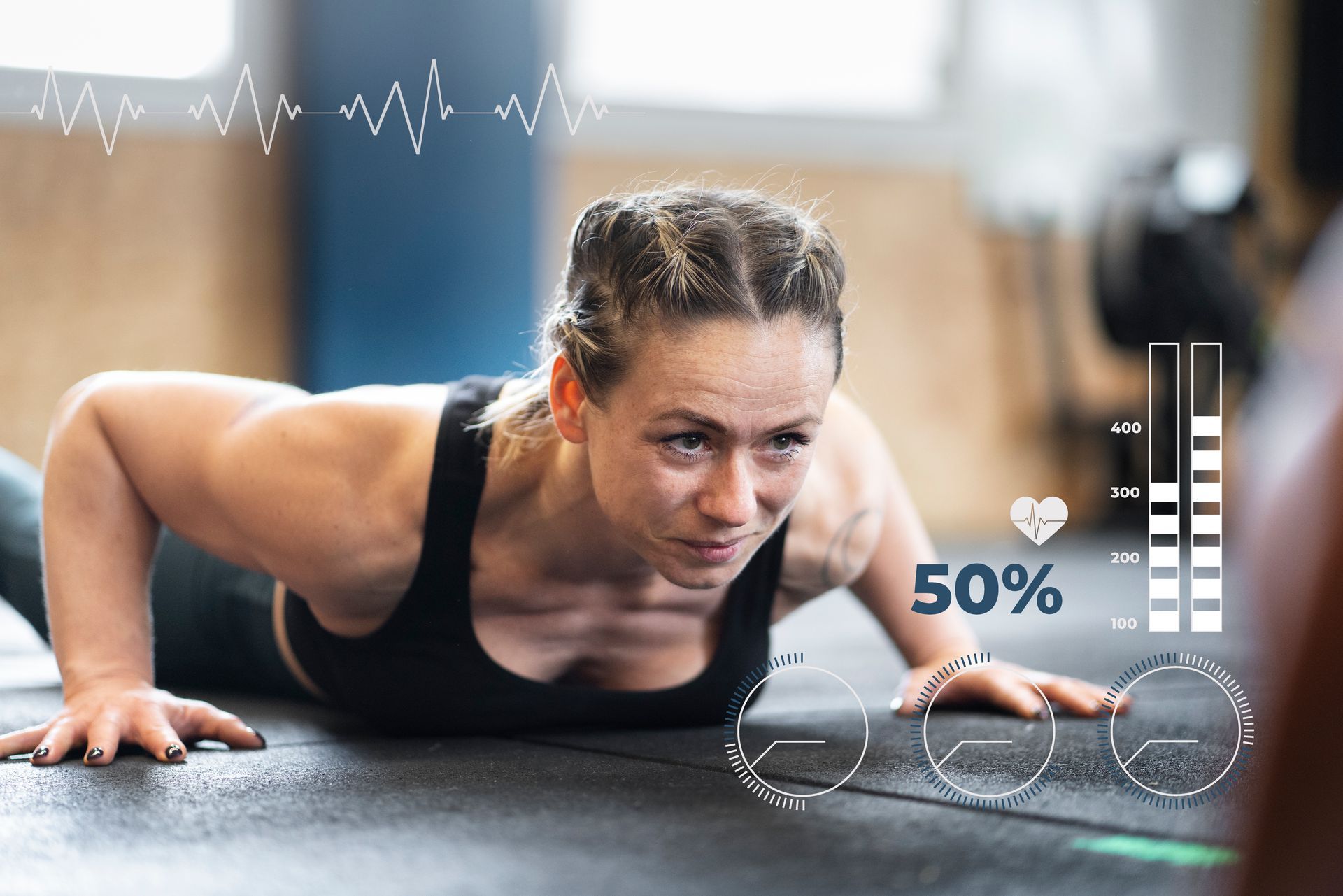 A woman is doing push ups on the floor in a gym.