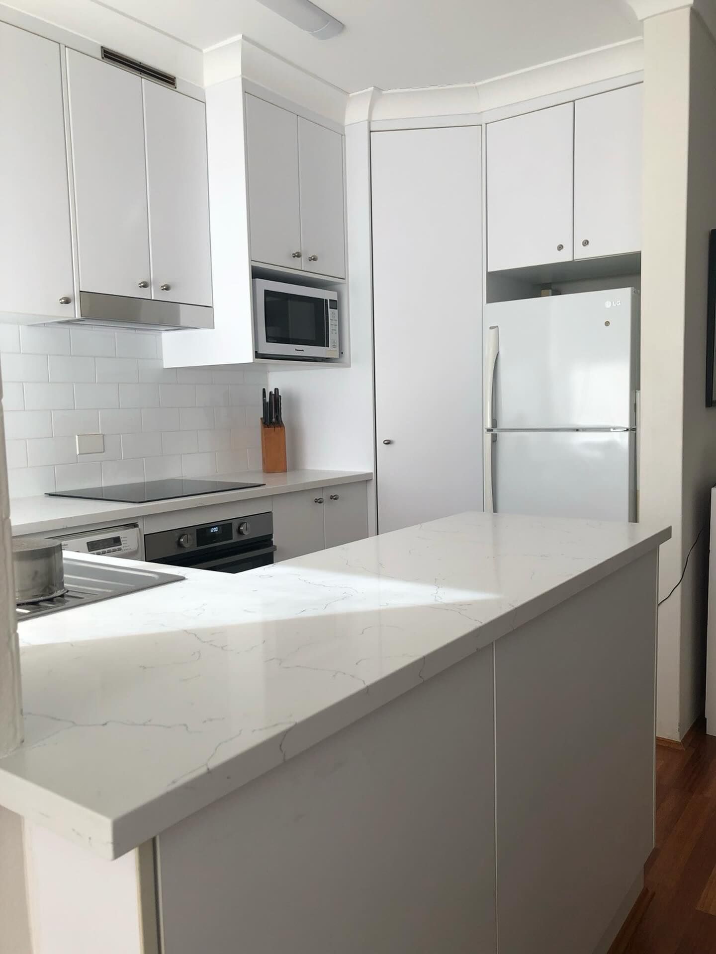 A Kitchen With White Cabinets and a White Refrigerator — Stephen Veigel Kitchens In Gosford, NSW