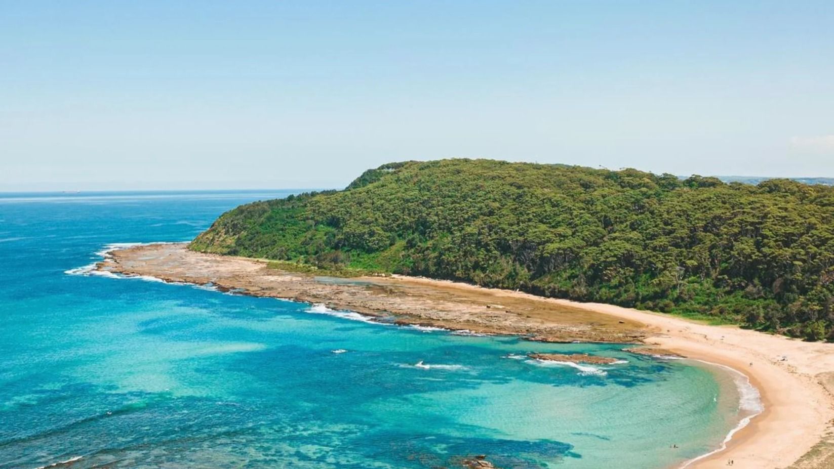 An Aerial View of a Beach With a Lush Green Hill in the Background — Stephen Veigel Kitchens In Gosford, NSW