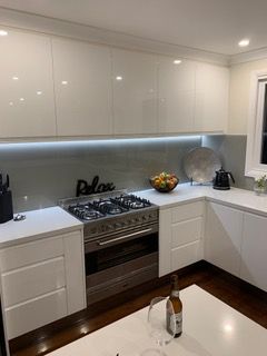 Modern white kitchen with stainless steel oven, fruit bowl, and overhead cabinet - Stephen Veigel Kitchens In Gosford, NSW