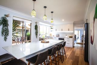 Open plan kitchen with white island benchtop table - Stephen Veigel Kitchens In Gosford, NSW