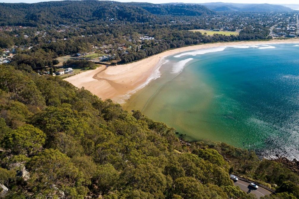 An Aerial View of a Beach Surrounded by Trees and a Body of Water — Stephen Veigel Kitchens In Gosford, NSW