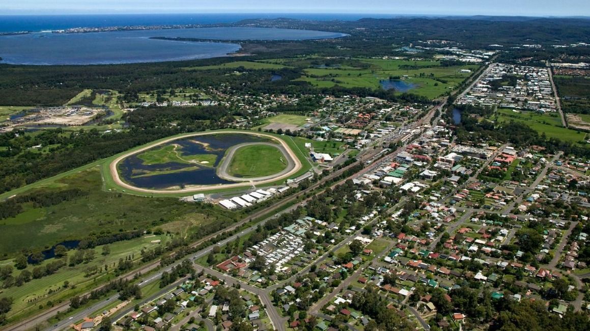 An Aerial View of a City With a Race Track and a Lake in the Background — Stephen Veigel Kitchens In Gosford, NSW