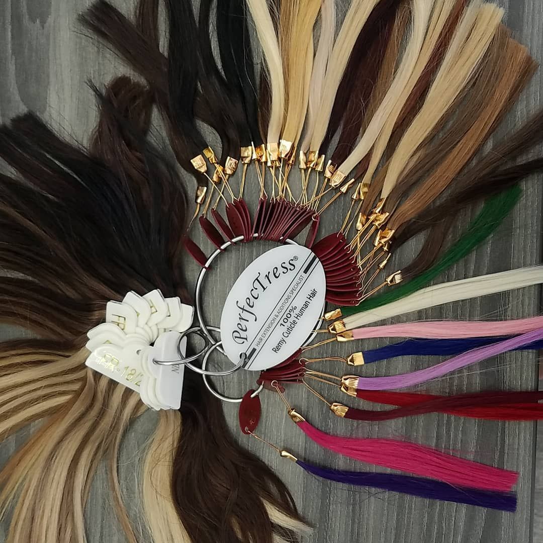 Hair color swatches on a circular holder, ranging from dark brown to blonde and including various bright colors.