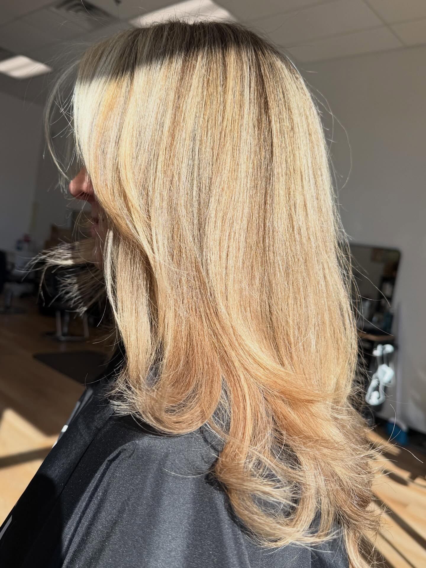 Blond hair with layered ends, angled towards sunlight.