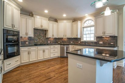 A kitchen with a large island in the middle of it.