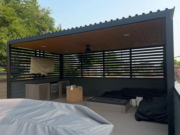 Outdoor patio with a pergola, furniture, and a fire pit.