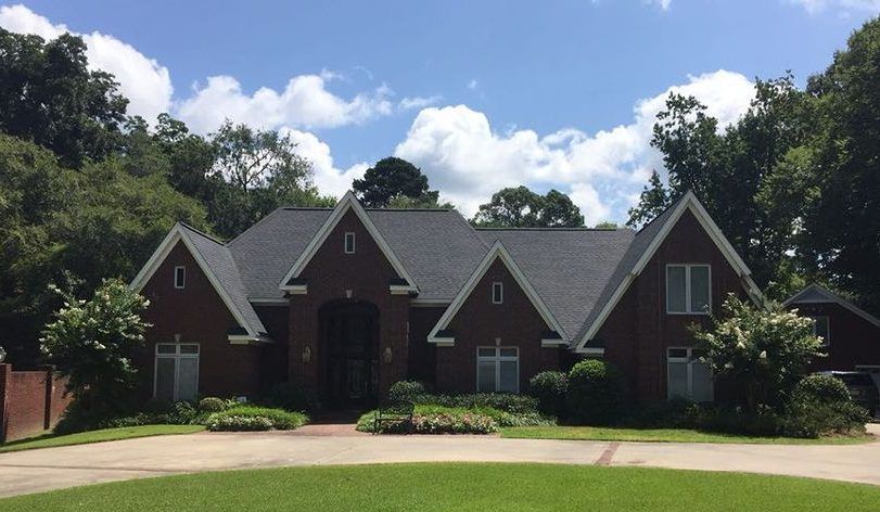 A large brick house with a gray roof