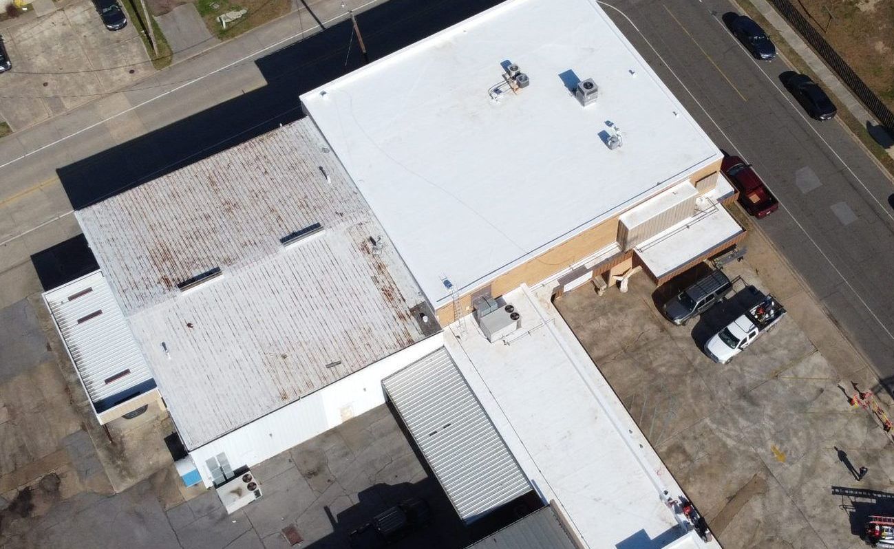 An aerial view of a building with a white roof.
