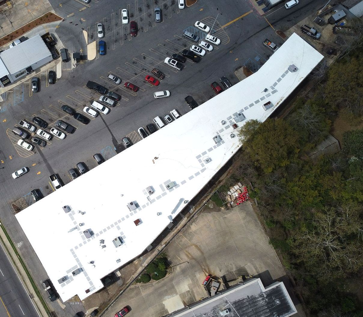 An aerial view of a building with a white roof