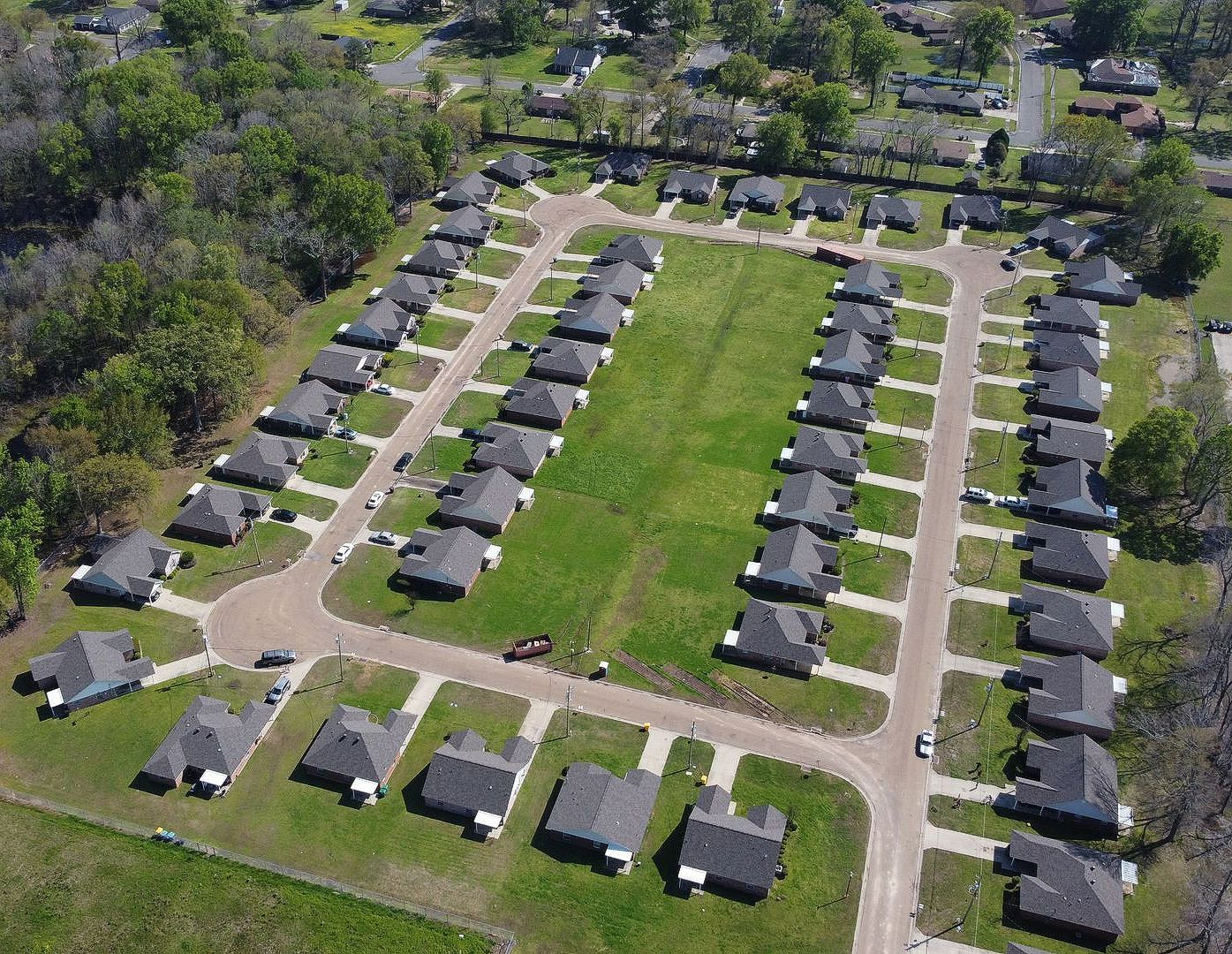 An aerial view of a residential area with lots of houses and trees.