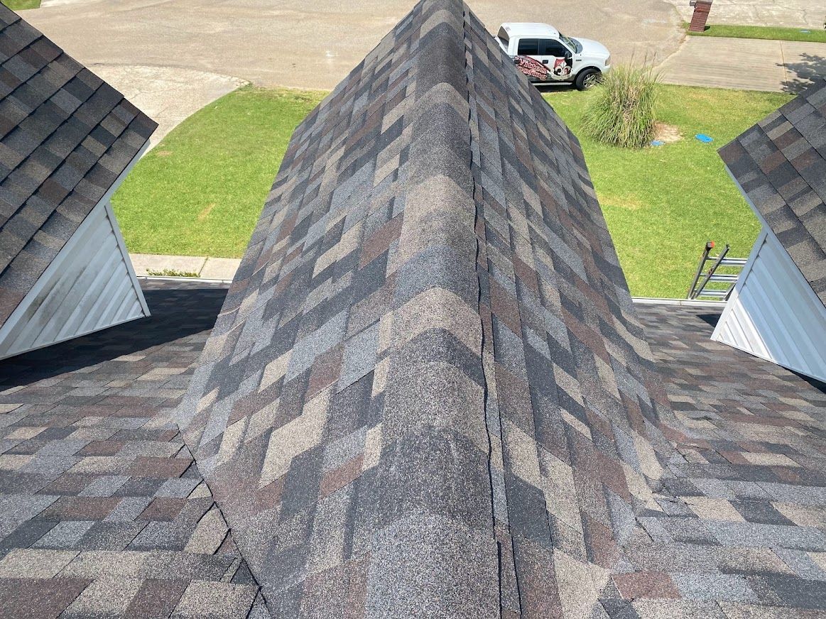 A close up of a roof with a truck parked in the background.
