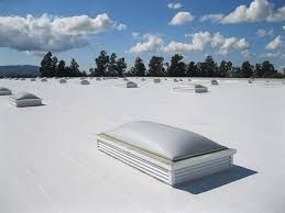 A white roof with a skylight on top of it.