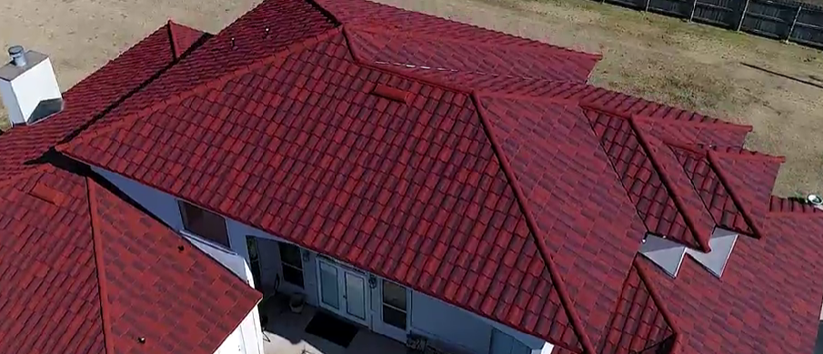 An aerial view of a house with a red roof.