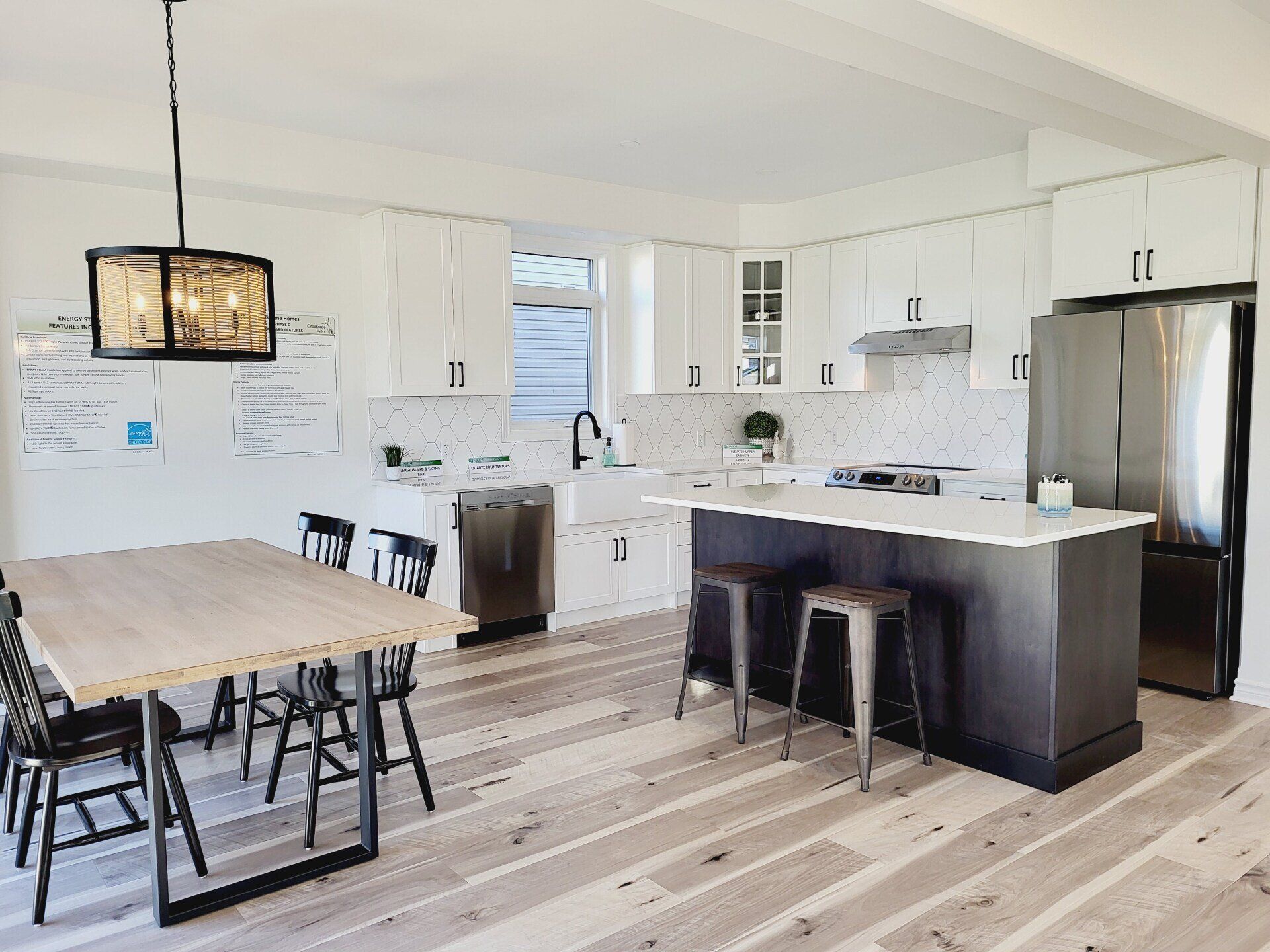 A kitchen with a table and chairs and a refrigerator.