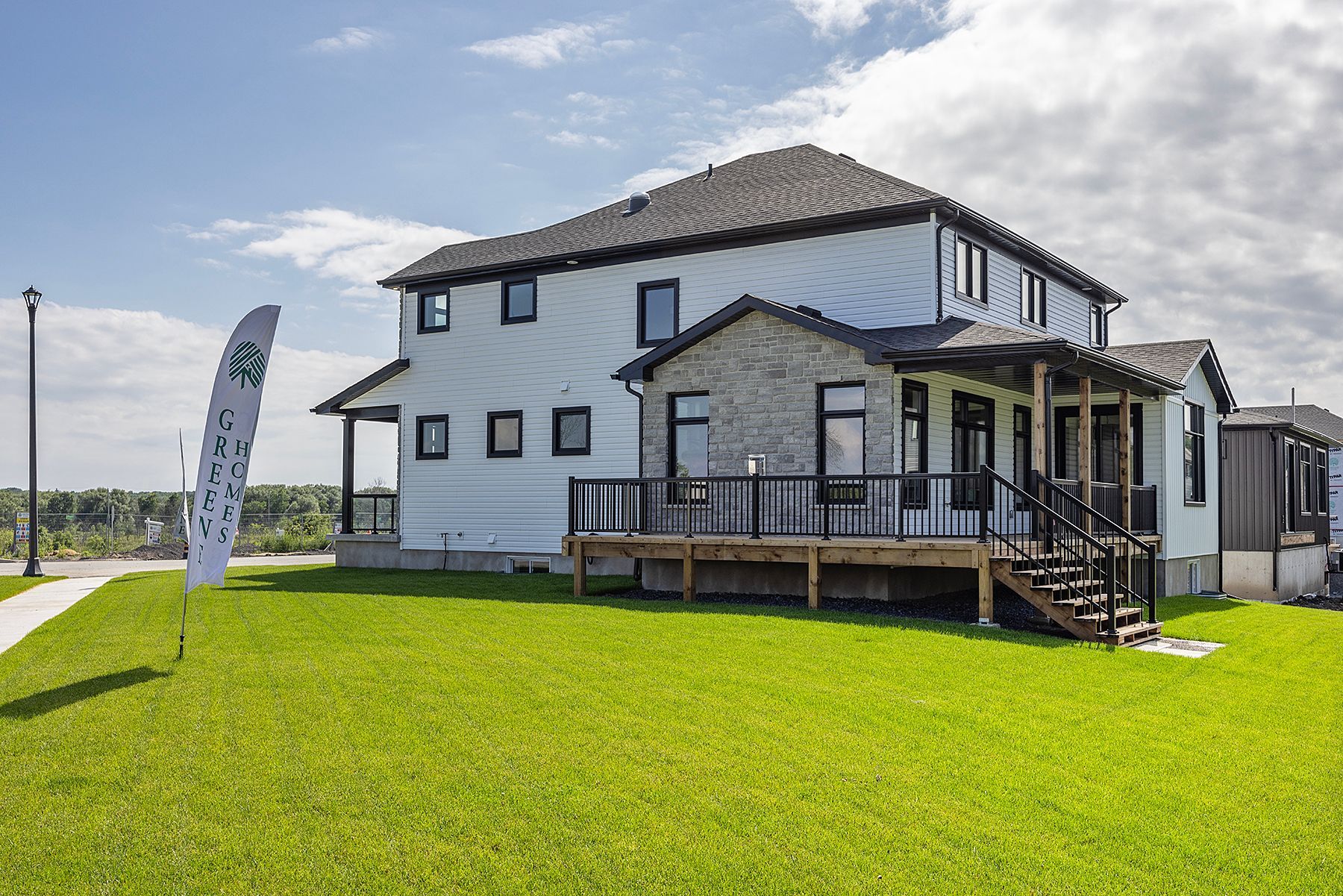 A large white house with a large lawn in front of it.