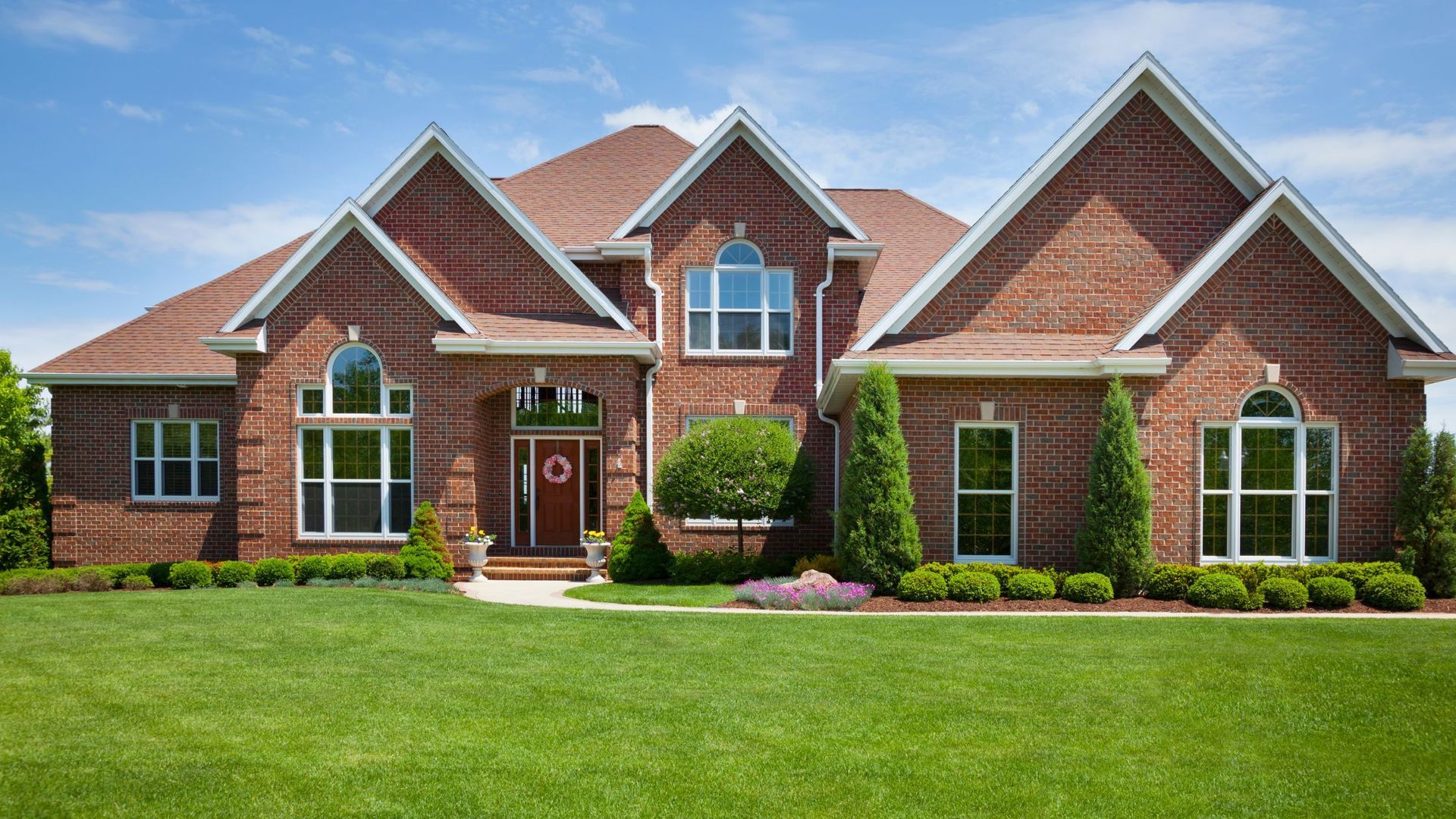 Big Brown House with a huge yard of green grass and trees