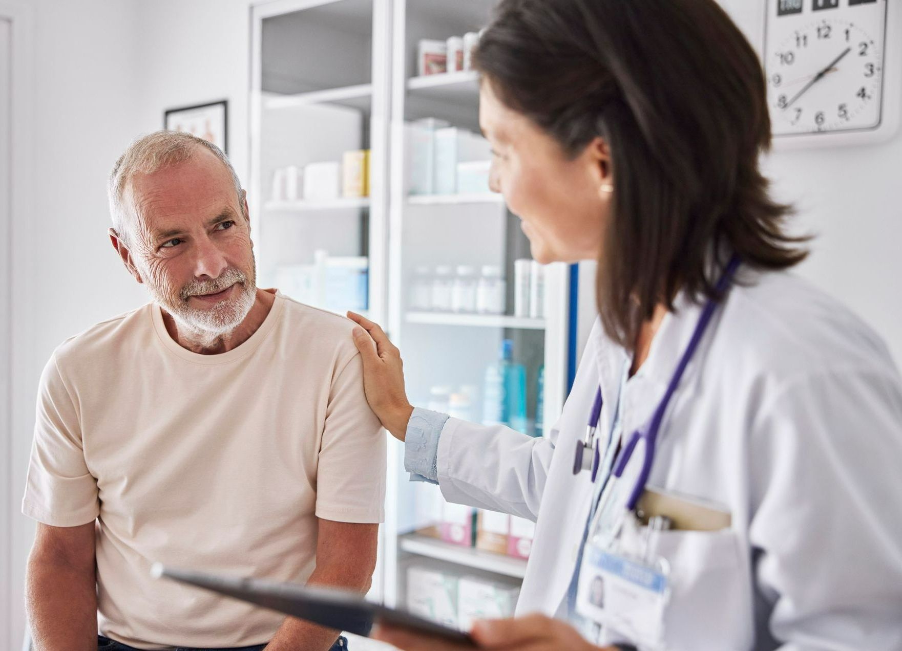 A woman is getting an ultrasound from a doctor.