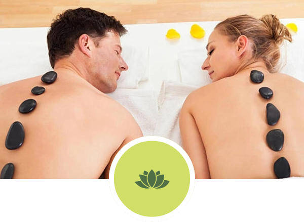 A man and a woman are getting a hot stone massage