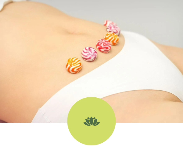 A woman laying down with candy on her stomach