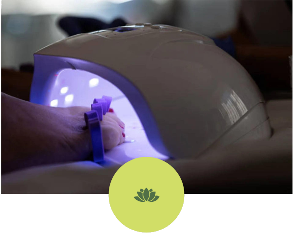 A person is getting their nails done in a nail dryer