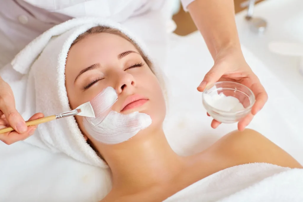 A woman is getting a facial treatment at a spa.