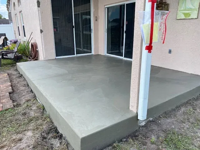 Construction site with concrete forms, rebar, and a yellow crane. Construction site with concrete forms, rebar, and a yellow crane.