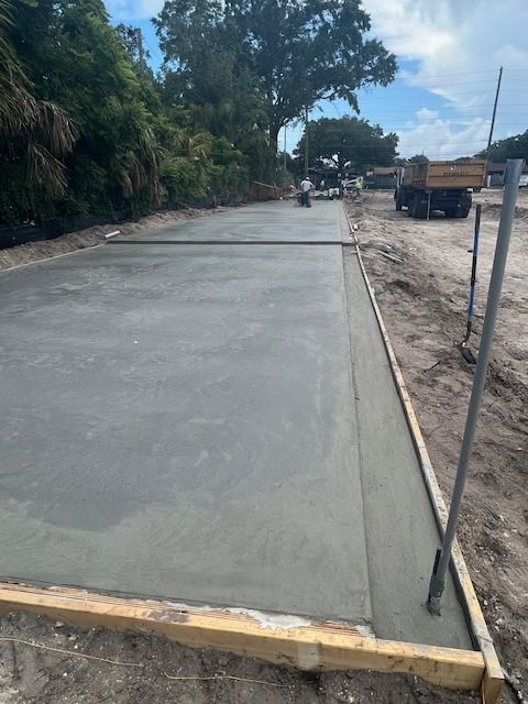 Freshly poured concrete slab with wooden formwork, outdoors. Freshly poured concrete slab with wooden formwork, outdoors.