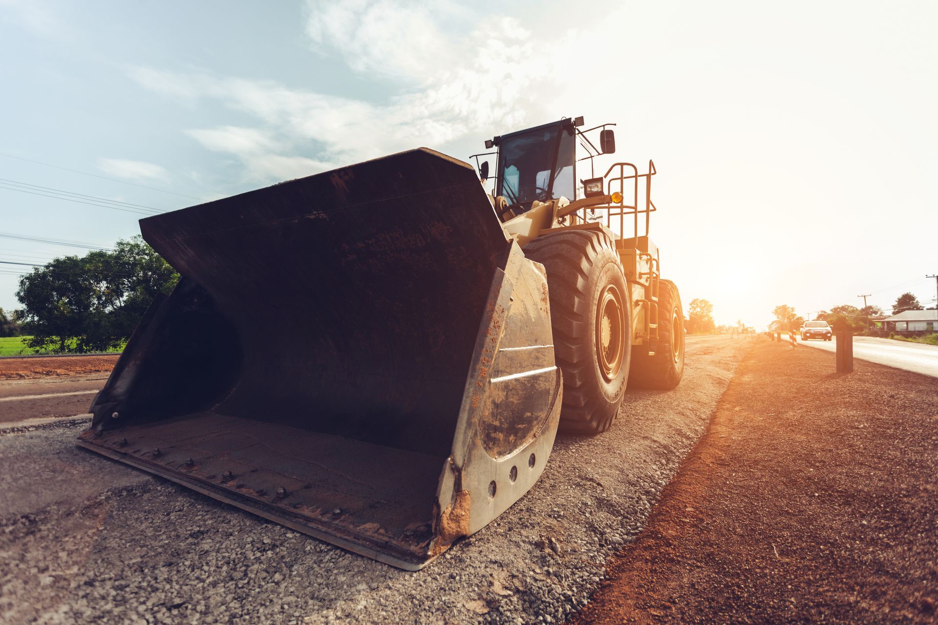 Skid steer removing concrete from a paved surface. Red gas can sits nearby. Skid steer removing concrete from a paved surface. Red gas can sits nearby.