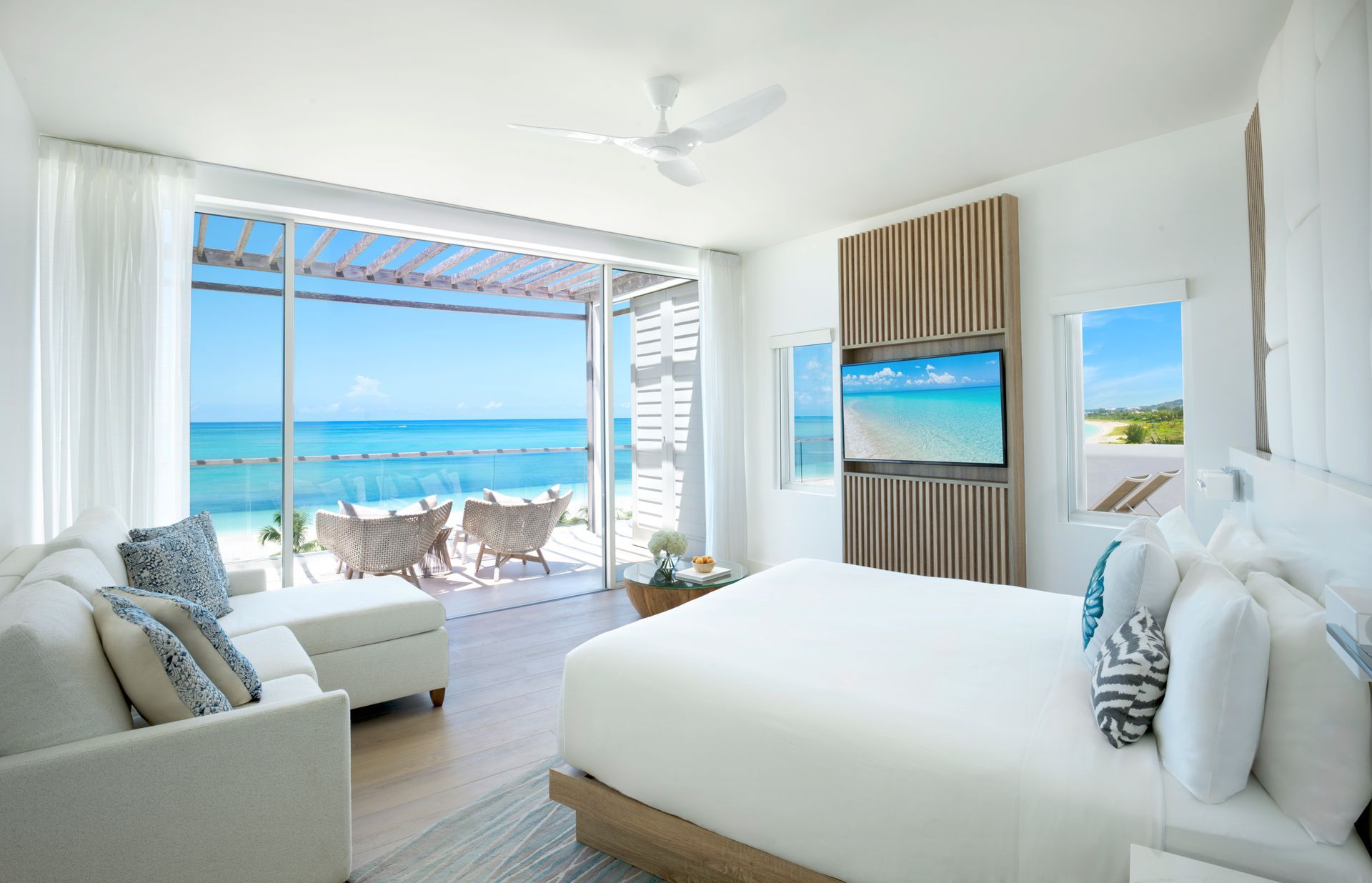 A hotel room with a large bed and a view of the ocean