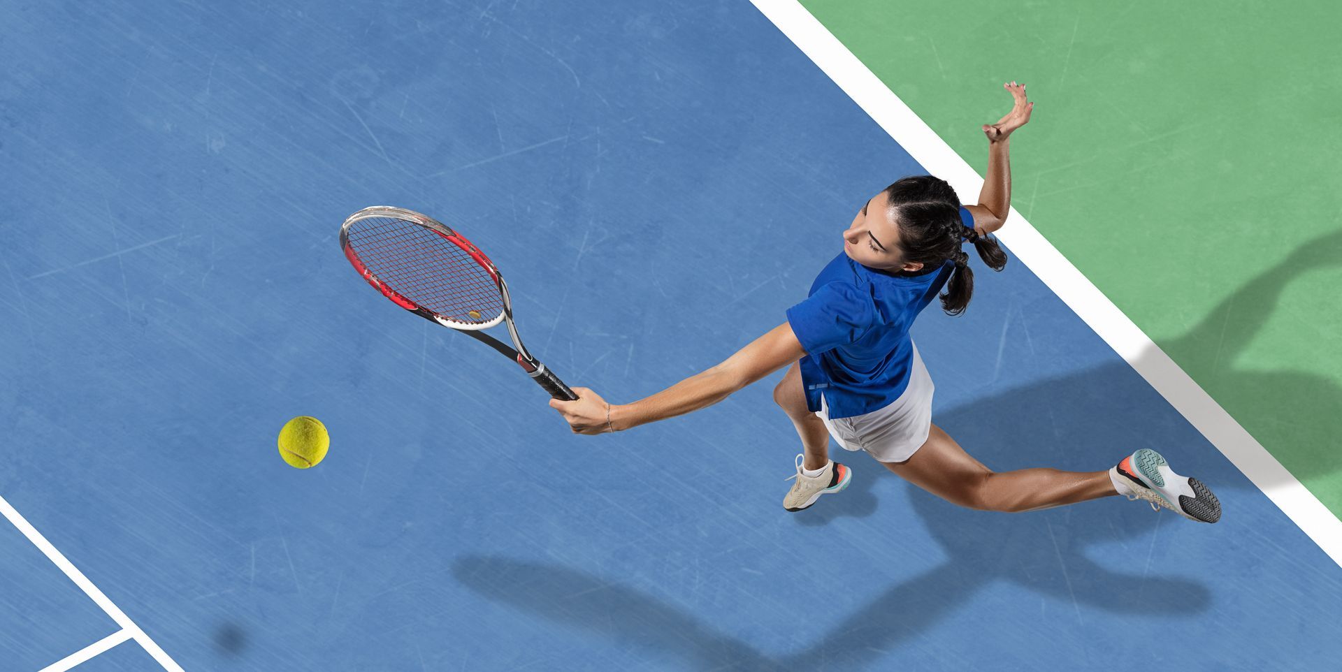 A woman in a blue shirt is playing tennis