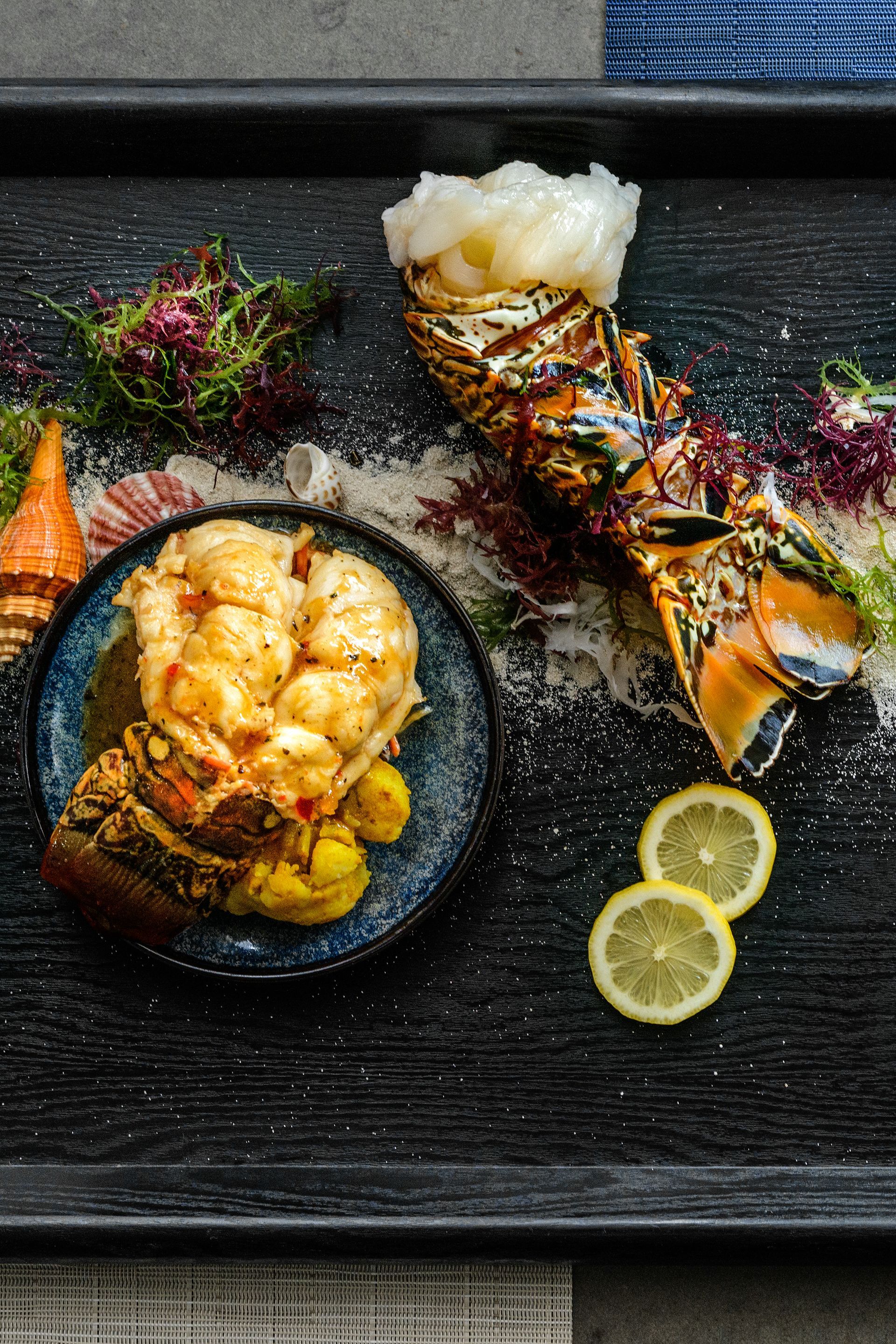 A close up of a plate of food with lemon slices