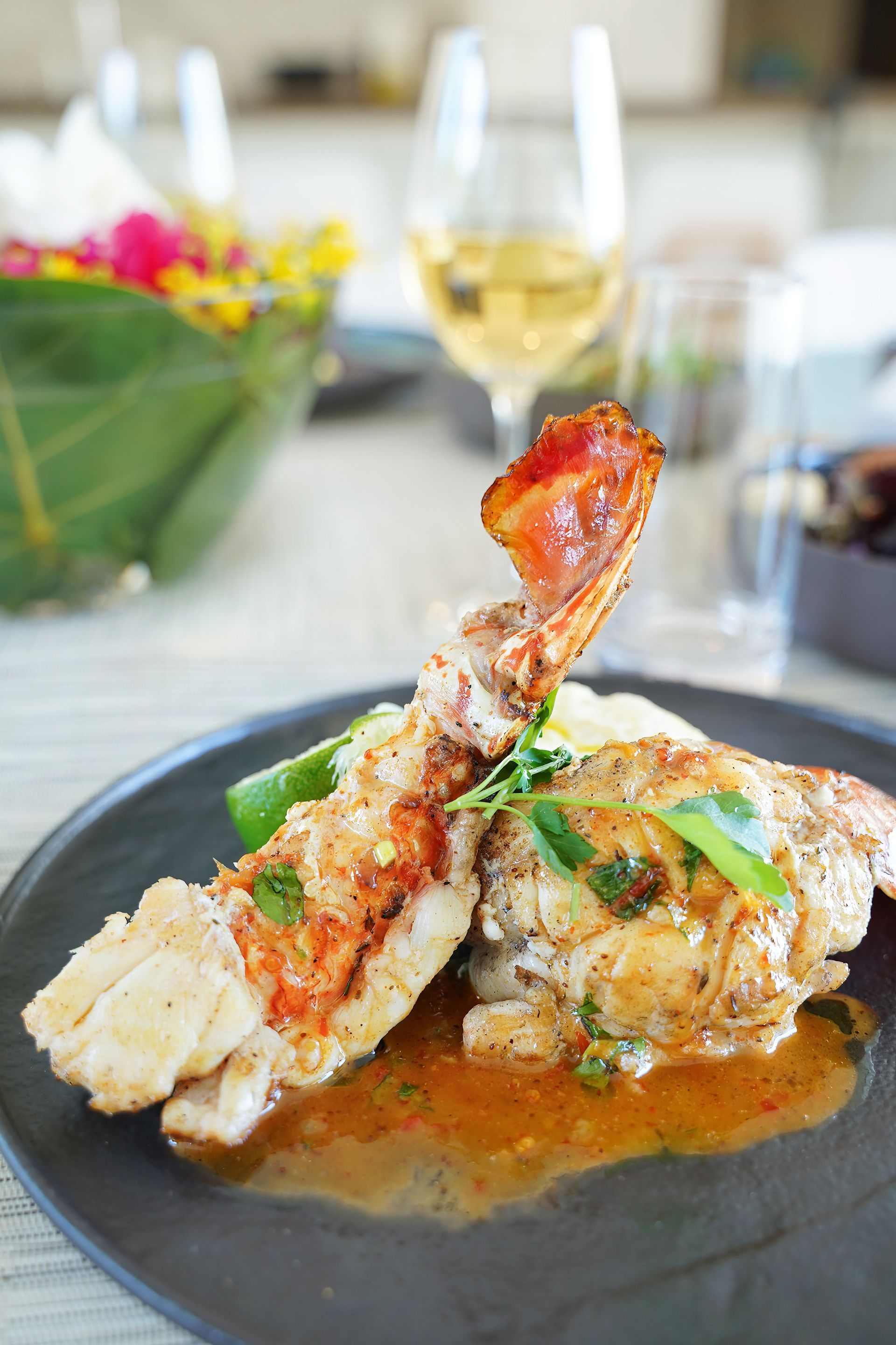 A table with plates of food and wine glasses on it