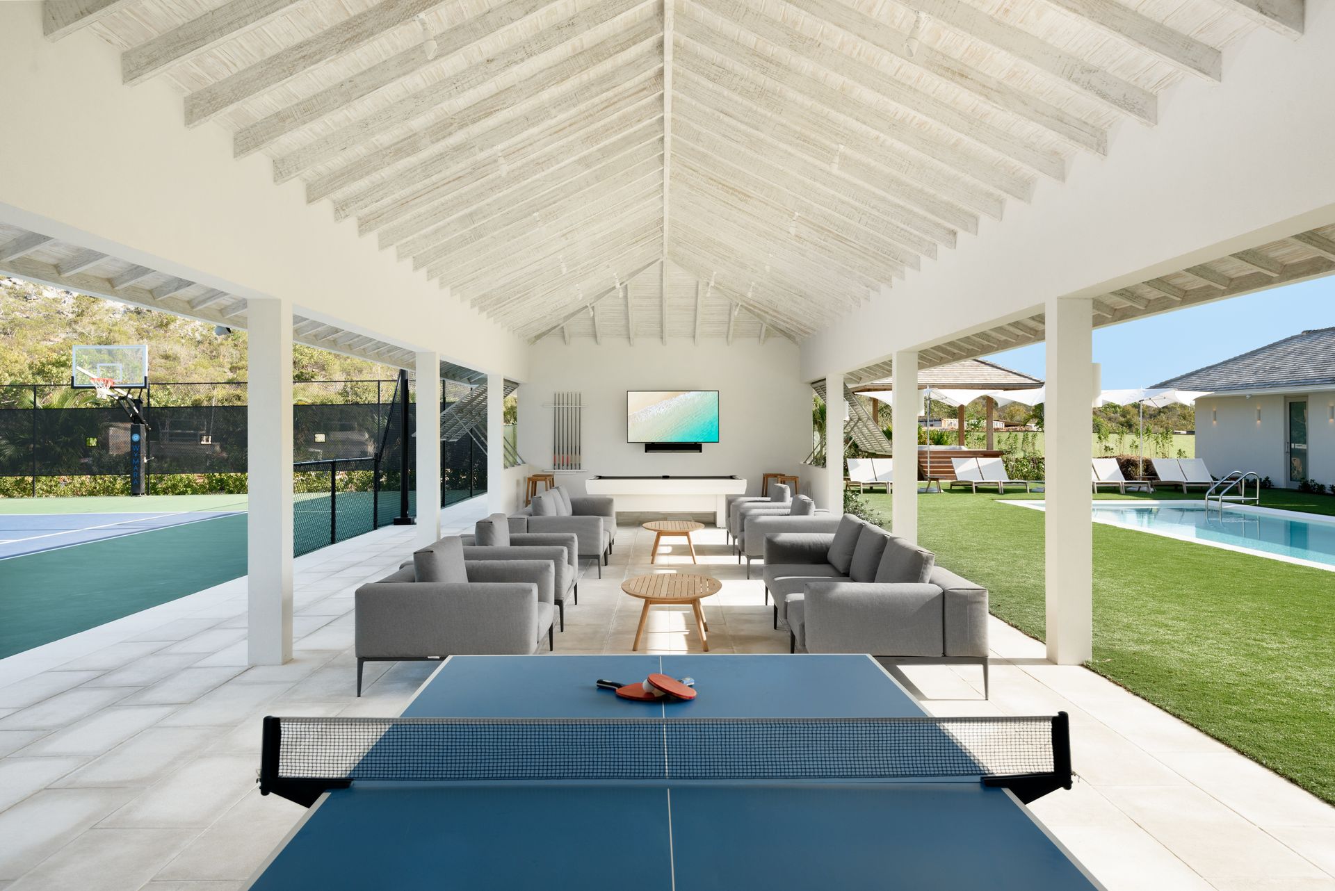 A ping pong table in the middle of a living room