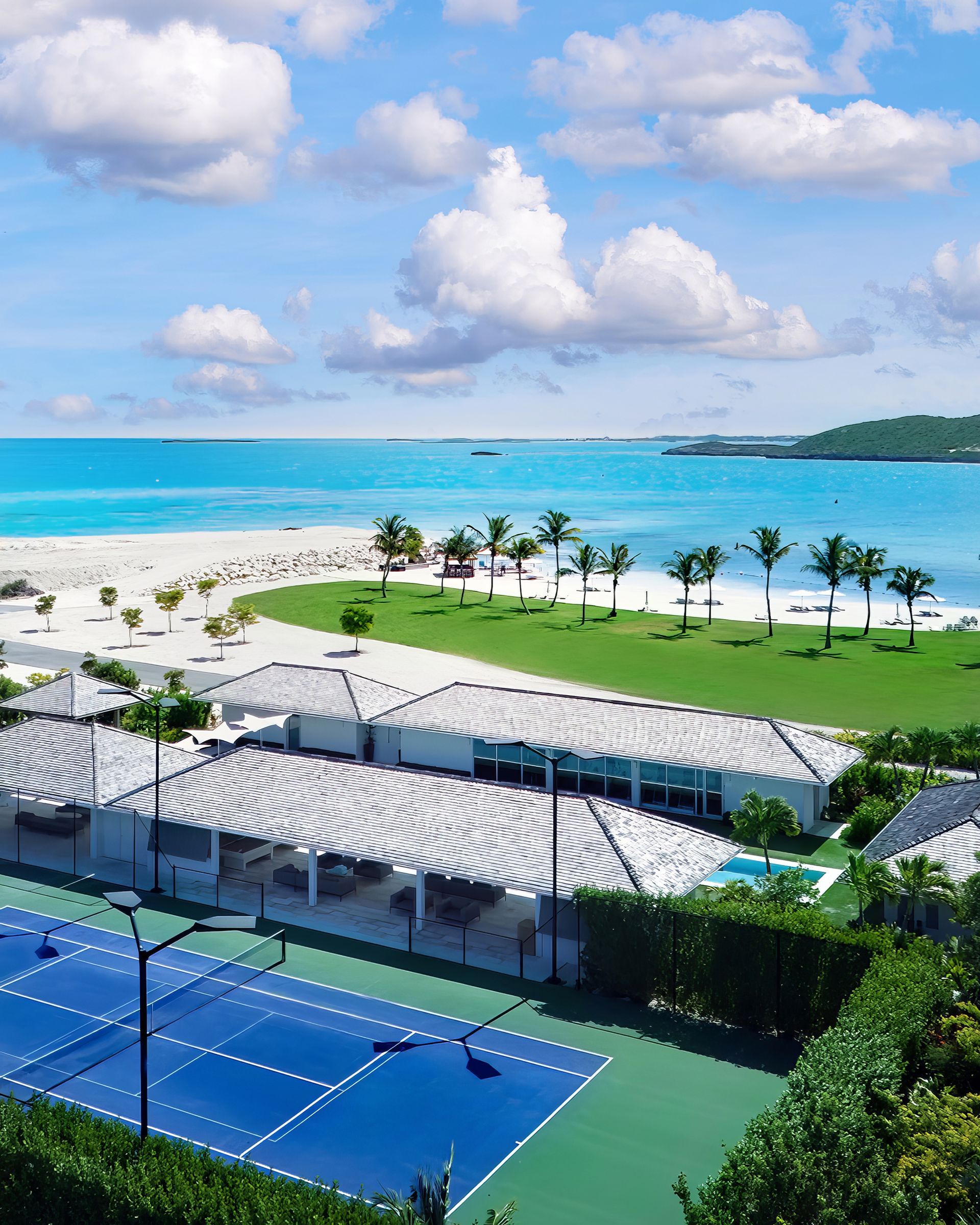 An aerial view of a tennis court and swimming pool