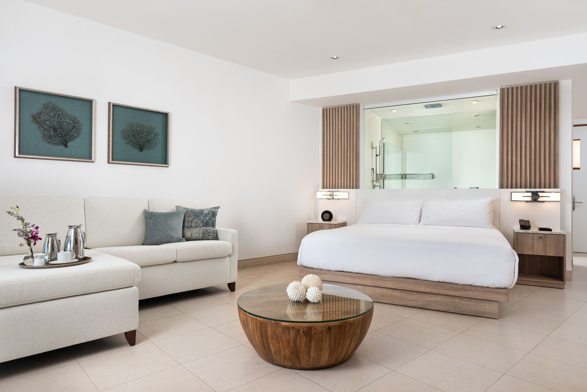 A hotel room with a king size bed a couch and a coffee table