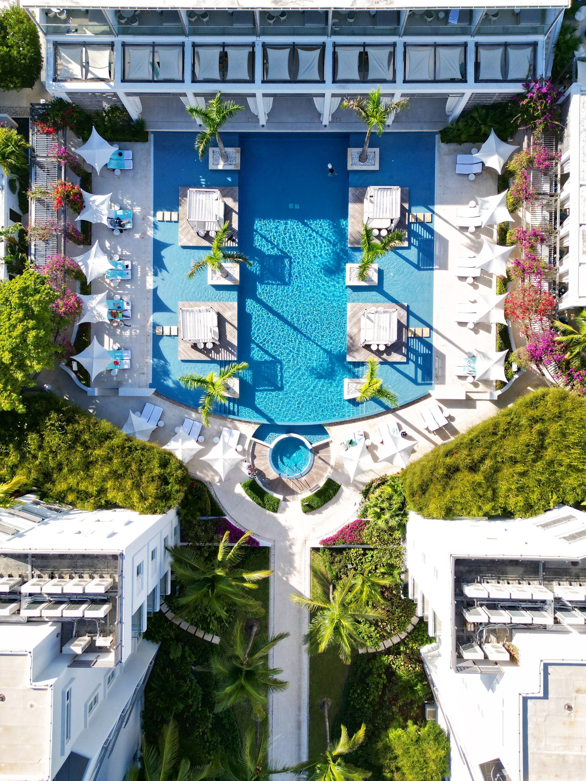 A wooden deck with chairs and umbrellas overlooking the ocean