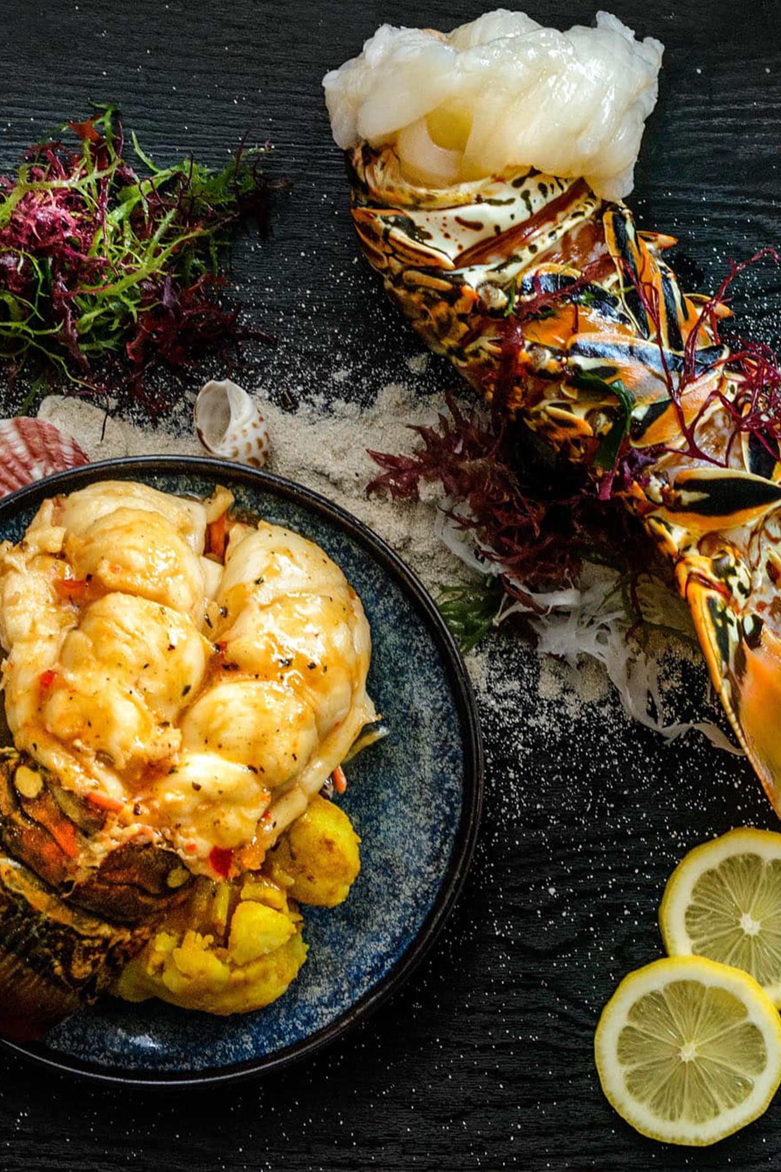 A close up of a plate of food with lemon slices