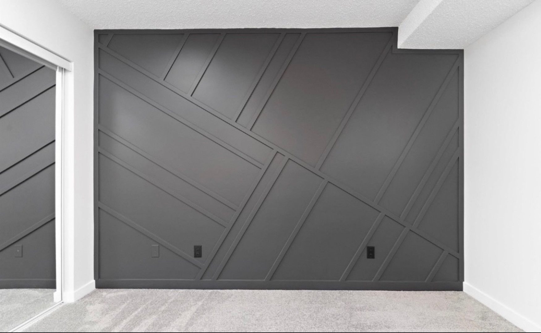 Modern gray wall with diagonal panel accents in a minimalist interior room
