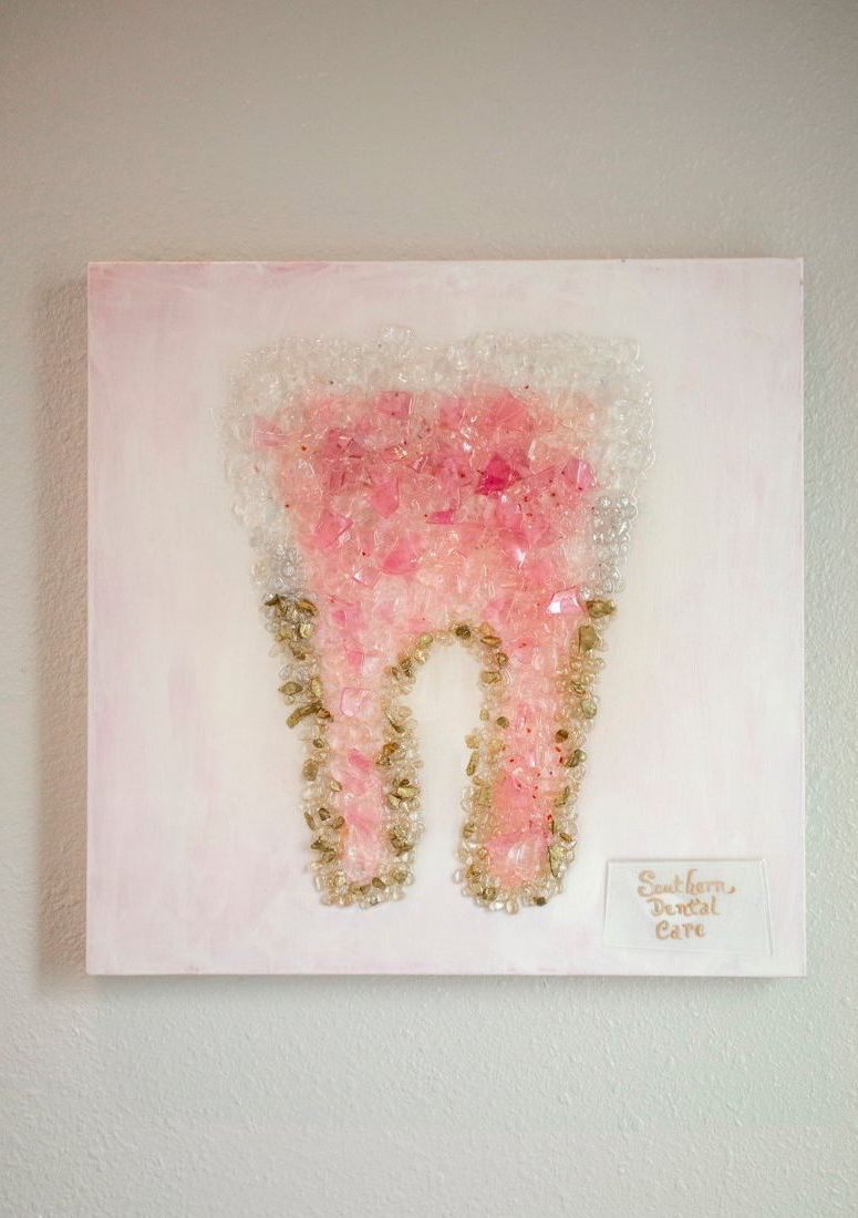 A close up of a painting of a tooth on a wall.
