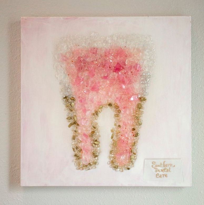 A close up of a painting of a tooth on a wall.