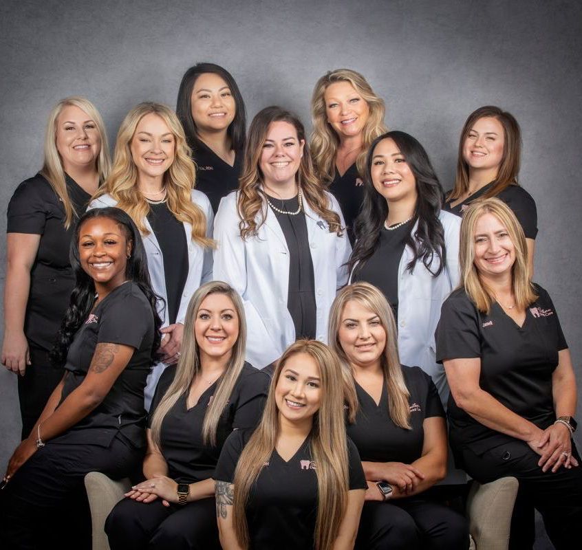 Dental office staff smiling | best root canal and nutrition coaching dentist in Marrero LA