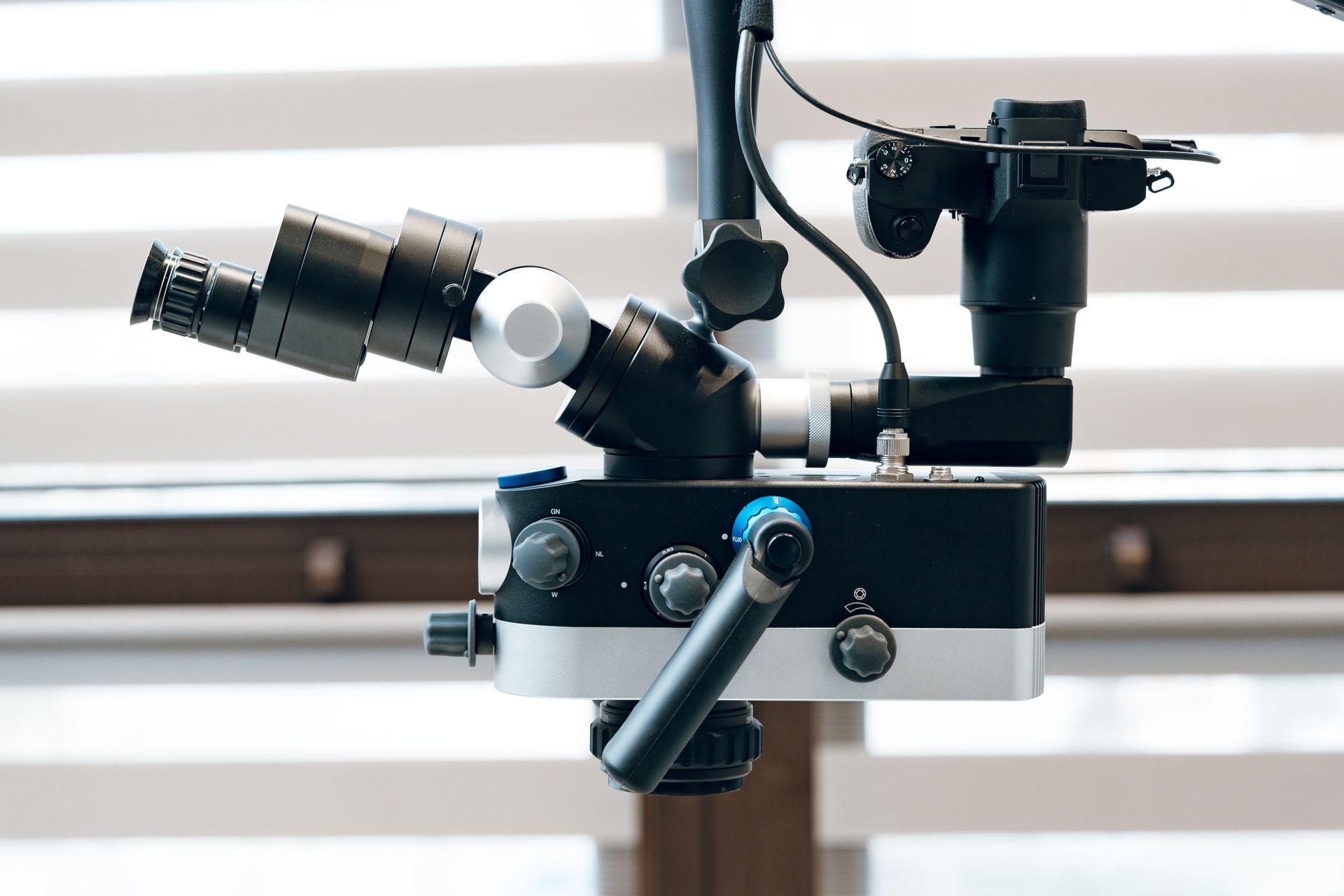 A dentist is examining a patient 's teeth under a microscope.